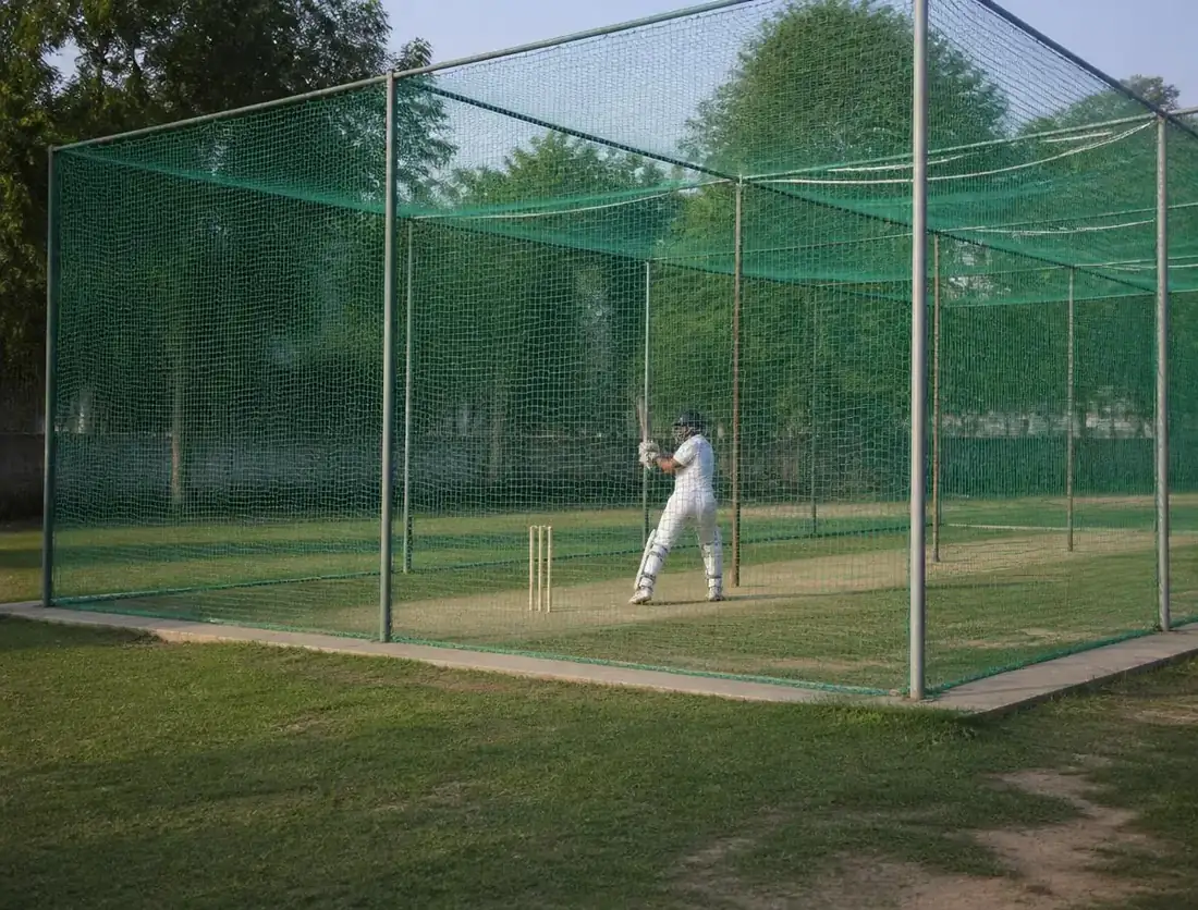Cricket practice net enclosure with a batsman practising inside